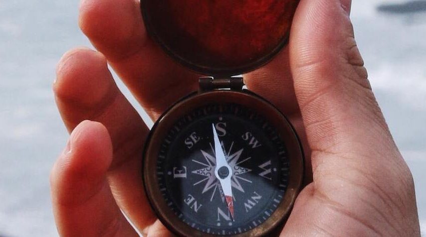 hand holding compass