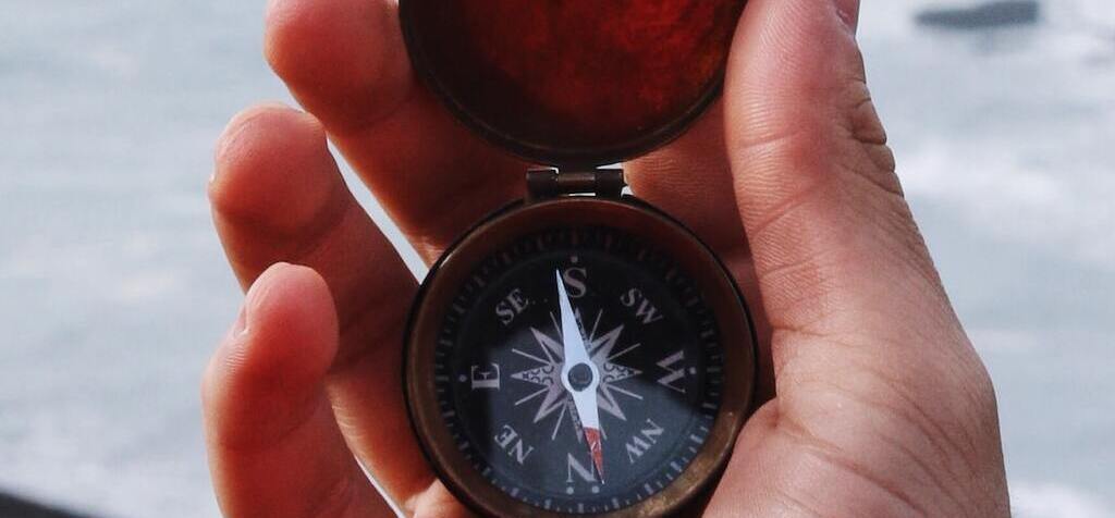 hand holding compass